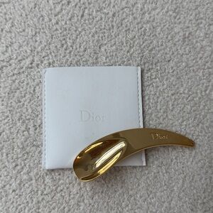 Dior gold spoon applicator.